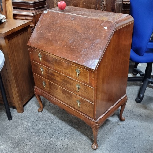 705 - A vintage bureau desk. A handsome piece with brass drop handles and three drawers on Queen Anne legs... 