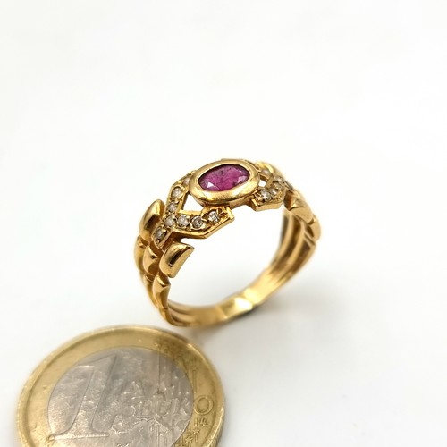 1 - A beautiful unmarked gold ring, set with a central Ruby stone setting and held with a sparkling gem ... 