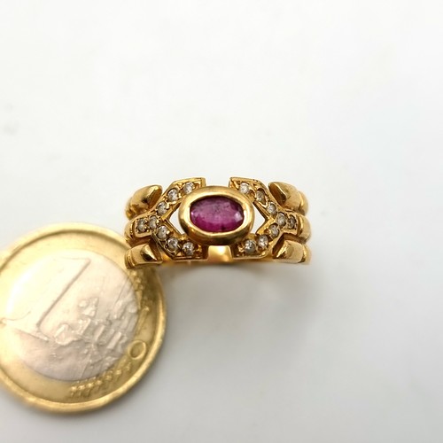 1 - A beautiful unmarked gold ring, set with a central Ruby stone setting and held with a sparkling gem ... 