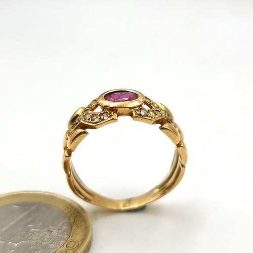 1 - A beautiful unmarked gold ring, set with a central Ruby stone setting and held with a sparkling gem ... 