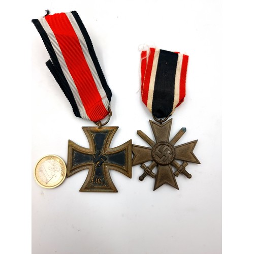 31 - Two World War II German original war medals, consisting of  a service cross second class, set with s... 