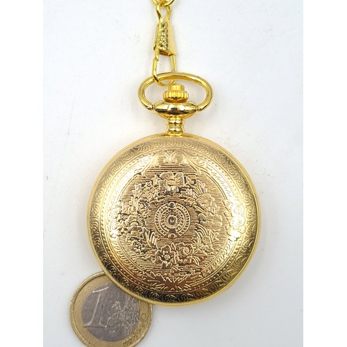 505 - A nicely embossed gilt toned quartz pocket watch, set with machine cut interior, a Grecian rider and... 