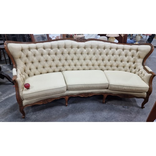 663 - Star Lot : A stunning vintage curved sofa with high winged back, diamond button back detailing, bras... 