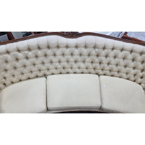 663 - Star Lot : A stunning vintage curved sofa with high winged back, diamond button back detailing, bras... 