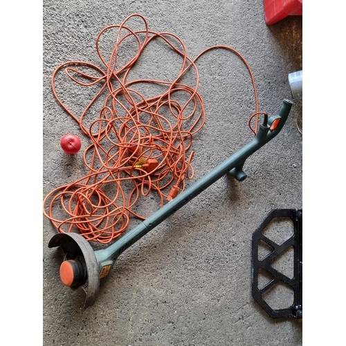 779 - A Black and Decker branded electric garden strimmer with 3 pin plug. Model no. GL540C/H2. has an ext... 