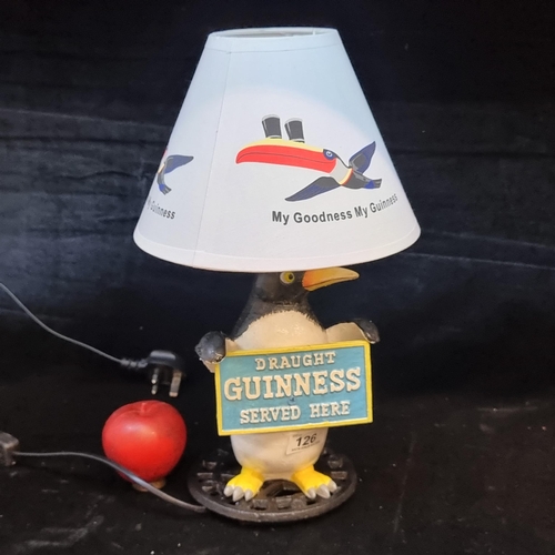 126 - A charming figural advertising lamp for Guinness. Featuring a cast metal Penguin figural base holdin... 