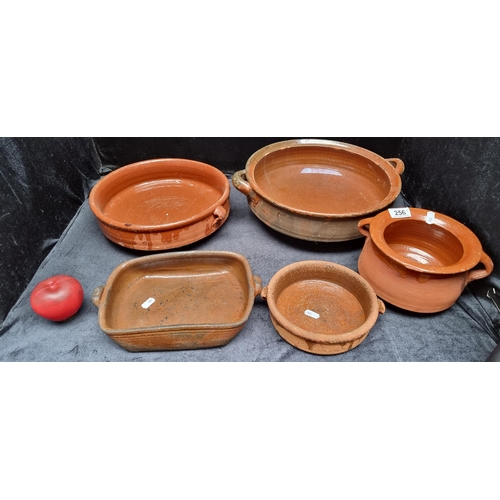 256 - Five vintage terracotta bowls including a large example with handles, a rectangular backing dish and... 