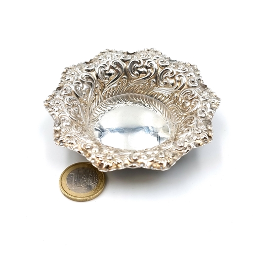 40 - A very pretty hallmarked sterling silver pin dish, set with Repousse embossed motif and star cut bor... 