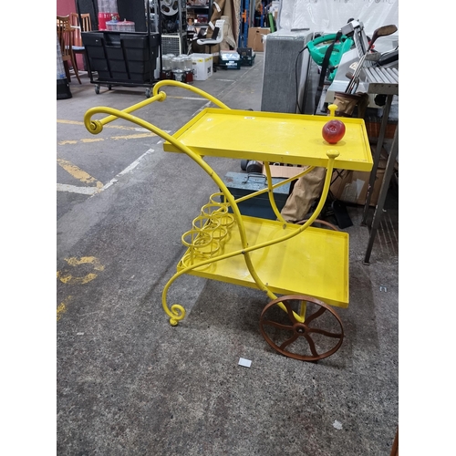 850 - A charming cast metal vendor's tray in a bright yellow finish. With a large pair of wheels and integ... 