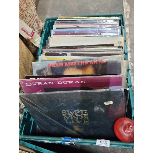 885 - A good crate containing approx. 100 LP vinyl records including artists such as Simple Minds, Rolling... 