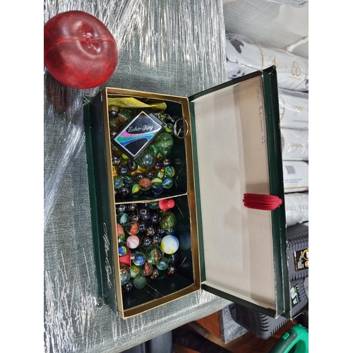 900 - A box containing approx. 40 marbles in various sizes and colours including examples in an iridescent... 