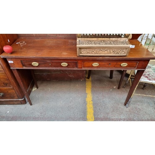 925 - Star Lot : An elegant antique mahogany console table with Regency style elements. Such as brass drop... 