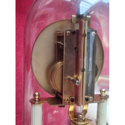 804 - A German made vintage Kern & Sohne dome clock with a rotating pendulum, highly ornate floral motifs,... 