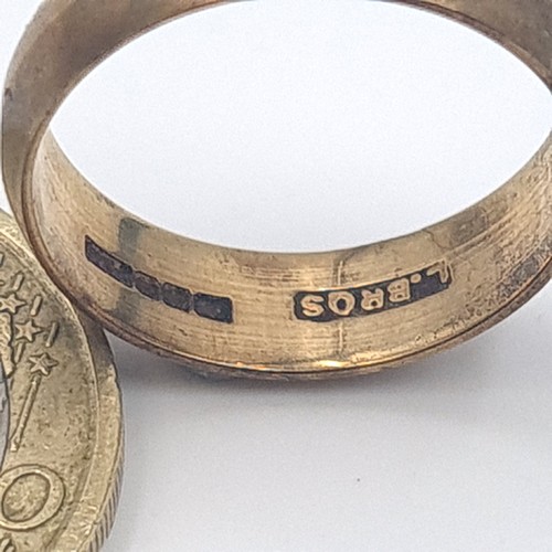 1 - A fine example of a thick banded 9 carat gold ring, stamped 375 and featuring the makers mark 