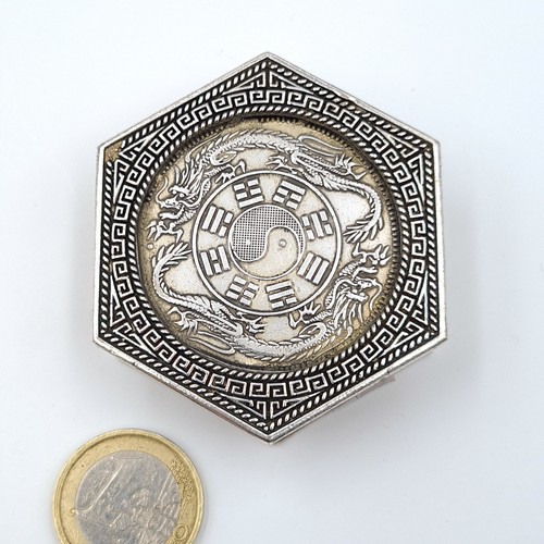 12 - A Chinese hexagonal pill box, set with profuse inlayed coins to face and reverse and featuring fabul... 