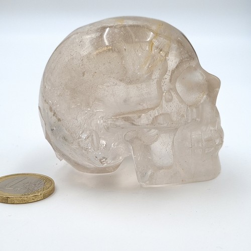 15 - An unusual natural clear carved quartz healing crystal in the form of a skull. The skull symbolizes ... 