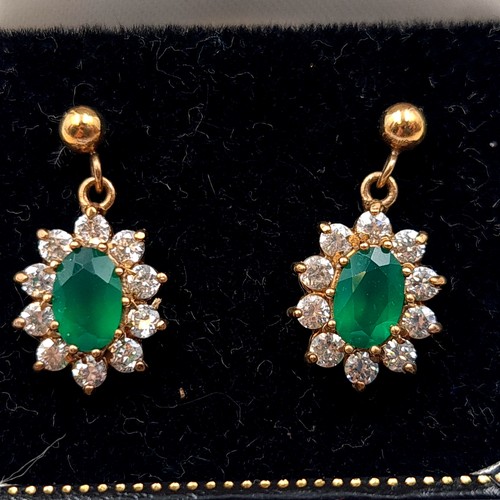 20 - Star Lot : A pair of very fine vintage 9 carat gold Emerald earrings, featuring a cluster halo of Wh... 