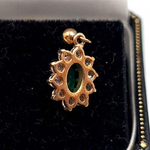 20 - Star Lot : A pair of very fine vintage 9 carat gold Emerald earrings, featuring a cluster halo of Wh... 