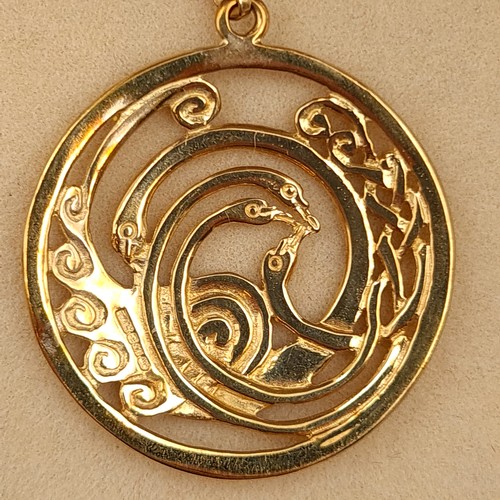 24 - Star Lot : A striking 9 carat gold disc pendant necklace, featuring a Celtic design of the Children ... 