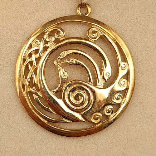 24 - Star Lot : A striking 9 carat gold disc pendant necklace, featuring a Celtic design of the Children ... 