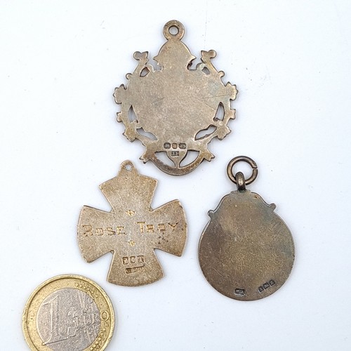 31 - A collection of three  silver medallions, comprising of two which are hallmarked Birmingham and both... 