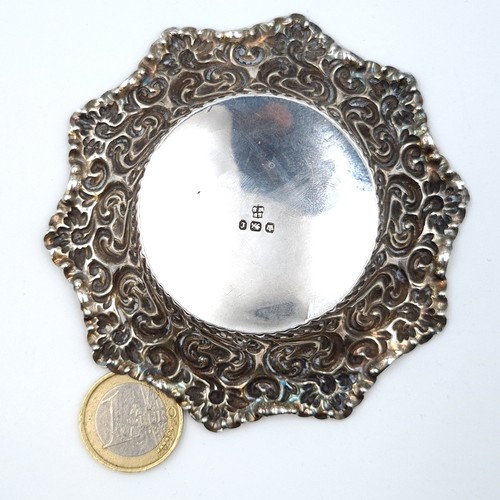 40 - A very pretty hallmarked sterling silver pin dish, set with Repousse embossed motif and star cut bor... 