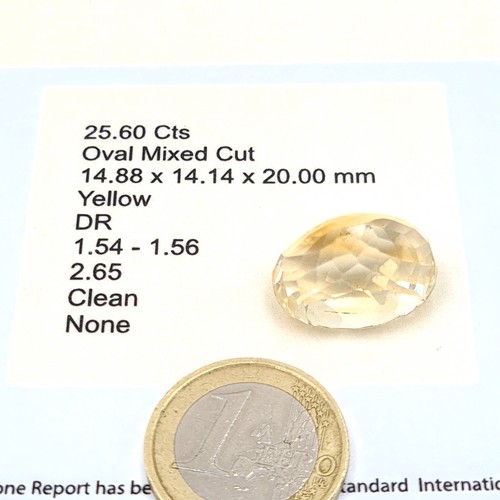 50 - A fully certified oval cut mixed citrine stone, of a large 25.60 carats. Comes with a full gli certi... 