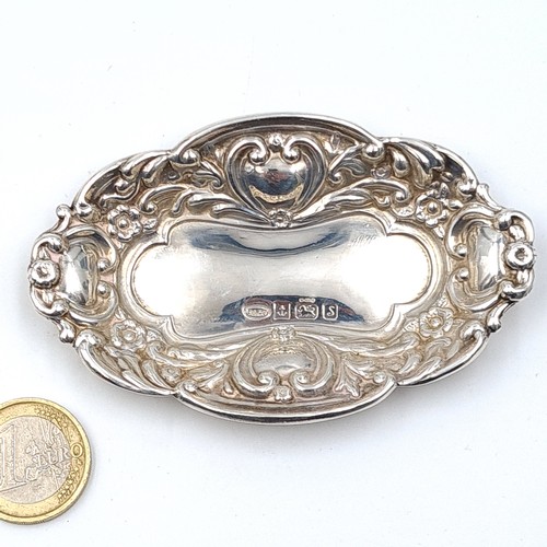 43 - An attractive sterling silver antique pin dish, featuring a Repoussé motif and an elliptical form. H... 