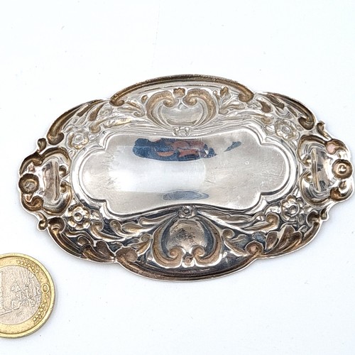 43 - An attractive sterling silver antique pin dish, featuring a Repoussé motif and an elliptical form. H... 