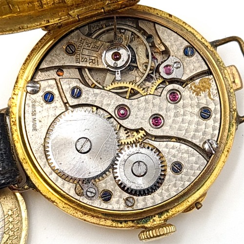 872 - Star Lot : A fine example of a vintage Half Hunter wrist watch, set with an 18 carat gold casing mar... 