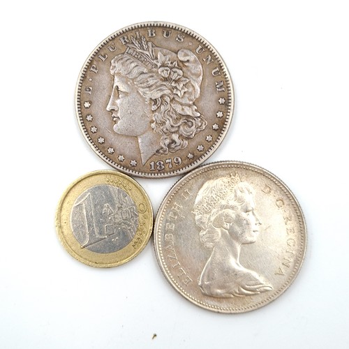 875 - Two coins, including a United States Morgan 1879 dollar coin (weight 26.76 grams). Together with a c... 