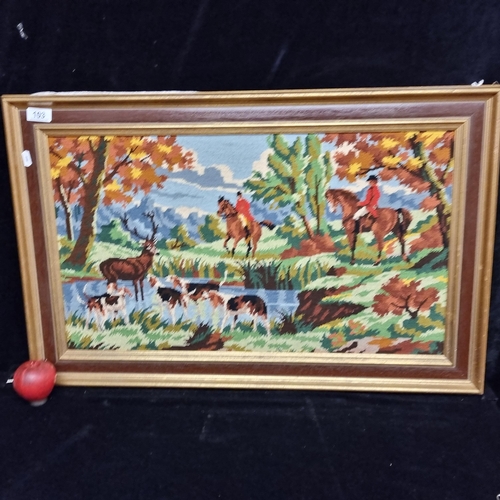 103 - A Vintage embroidered tapestry needlework featuring a woodland hunting scene with horses, hounds and... 