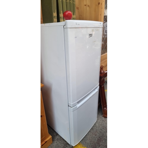 465 - A Beko standing refrigerator with freezer storage to base. CS5342APW. Total capacity 200L. Voltage 2... 