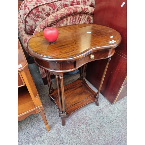 471 - An elegant kidney shaped side table with turned wood supports and neat drawer with brass pull handle... 