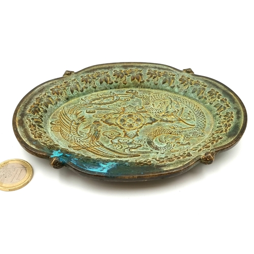 5 - A fine and heavy Qing Dynasty example of an elliptical bronze dish, featuring a swirling foliate mot... 