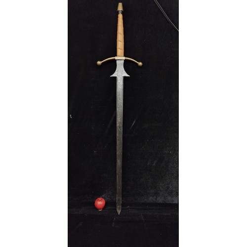 111 - A large Medieval style long sword. With a classic cruciform hilt with leather wrap and faintly inscr... 