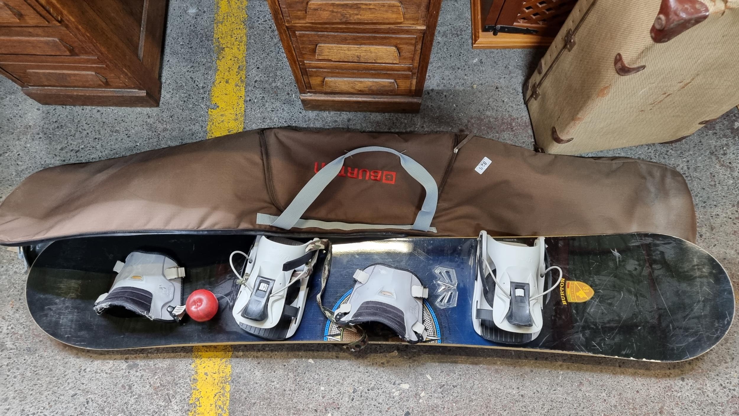 A Burton Royale 66 snowboard fitted with boot braces. Accompanied