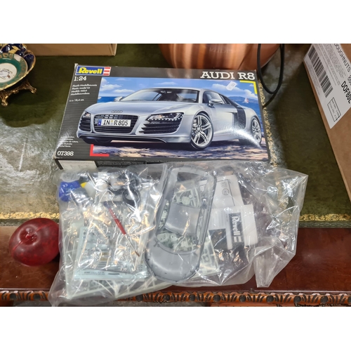 A Revell branded model kit of an Audi R8 car in the scale 1:24. Model is to  be self assembled. In or