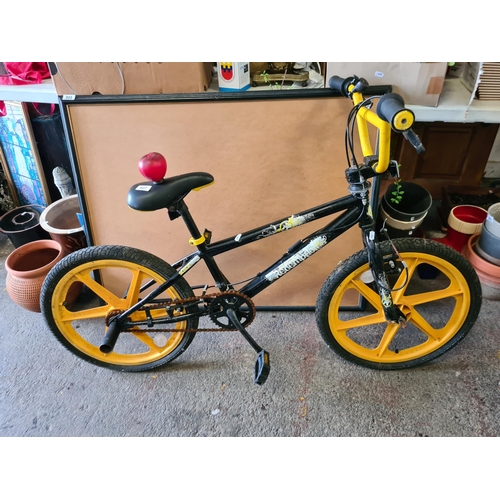 927 - A children's stunt bicycle from Redemption in a black and yellow finish.