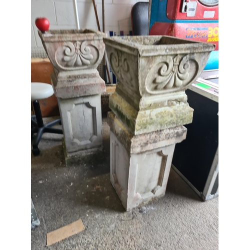 932 - Star Lot : A pair of large reconstituted stone outdoor planters with square Neoclassical style tops ... 