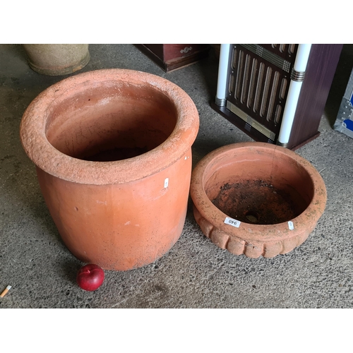 940 - Two large and heavy terracotta planters with a very big example (H43cm x D45cm). Along with an examp... 