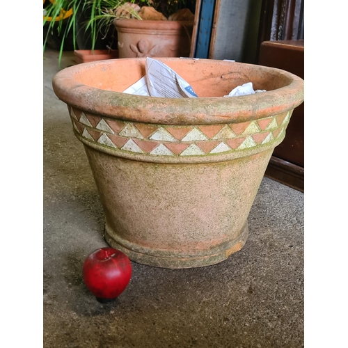 941 - A large terracotta planter with a border boasting a triangle design. H30cm x D42cm. Some chips to ba... 