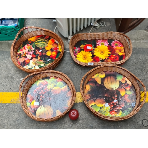 955 - A set of four brand new wicker baskets with vibrant bases featuring images of harvest vegetables and... 