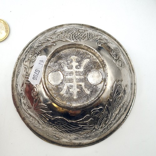 12 - A pair of vintage metal circular raised Chinese tea bowls, featuring Greek Key elements and traditio... 