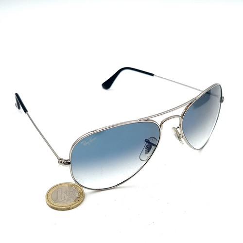 34 - A pair of genuine Ray-Ban aviator sunglasses, featuring metal frames and rare light blue lenses. Len... 