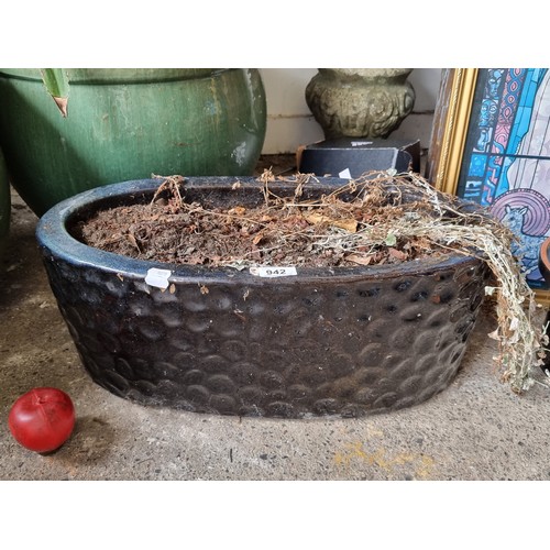 942 - A large oval ceramic planter in a deep navy glaze.