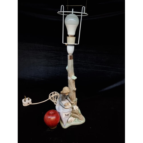 145 - A vintage Nao porcelain table lamp with figural base. In very good condition.