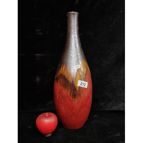 212 - A stylish ceramic art studio pottery vase in a maroon and brown glaze.