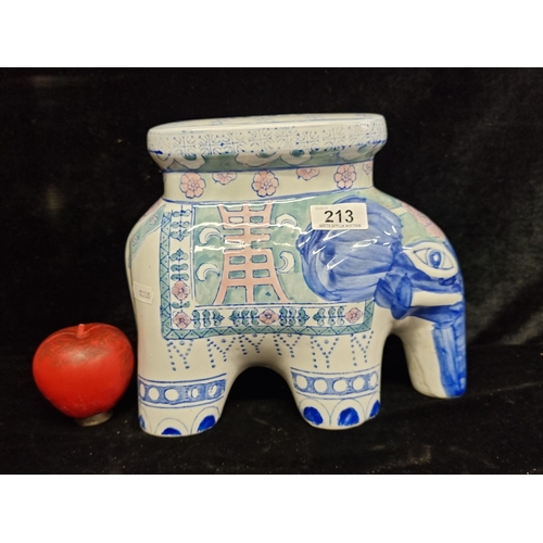 213 - A ceramic figure depicting an elephant with a surface to top in the form of a seat. In very good con... 