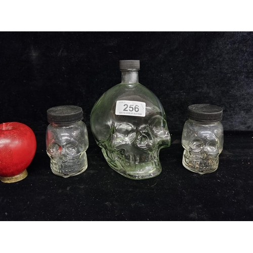 256 - Three glass skull jars with original jars. In very good condition.